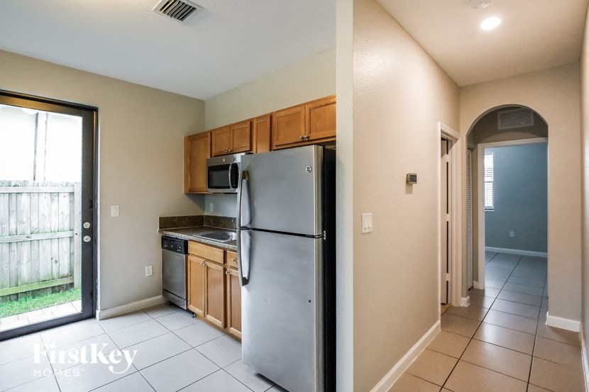 a kitchen with stainless steel appliances and wooden cabinets