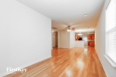 A room with wooden floors and a ceiling fan.