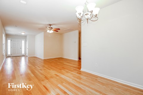 A room with wooden floors and a chandelier.