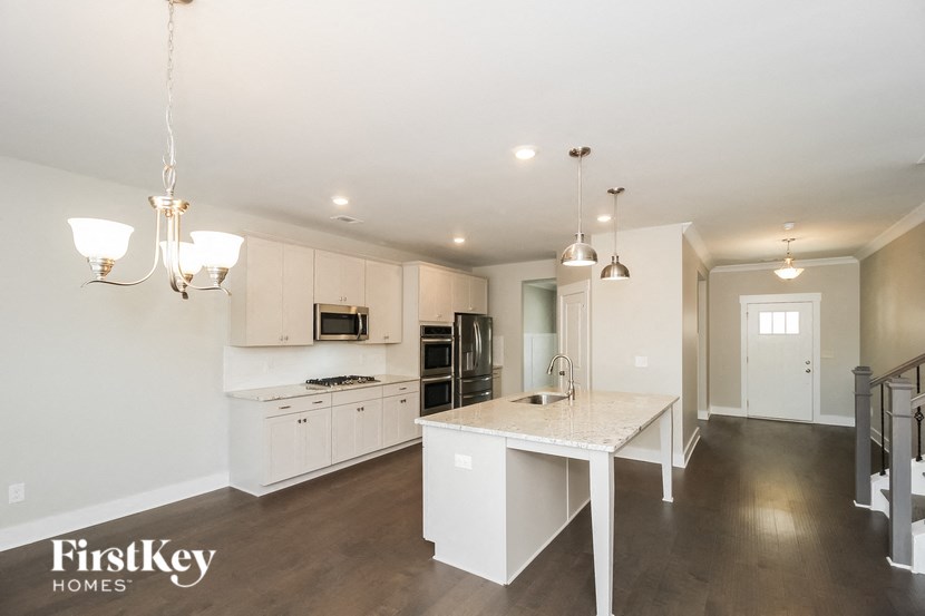 A kitchen with a table and chairs in the middle of the room.