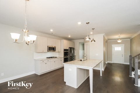 A kitchen with a table and chairs in the middle of the room.