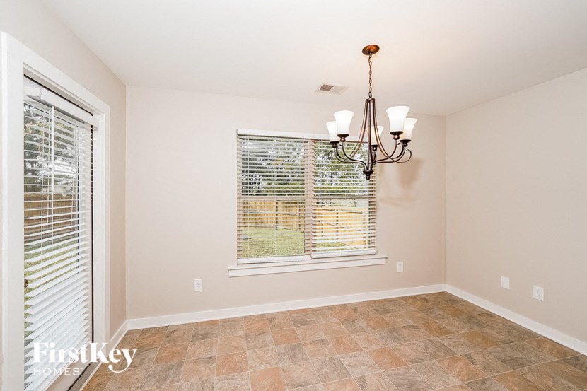 A room with a tiled floor and a chandelier.