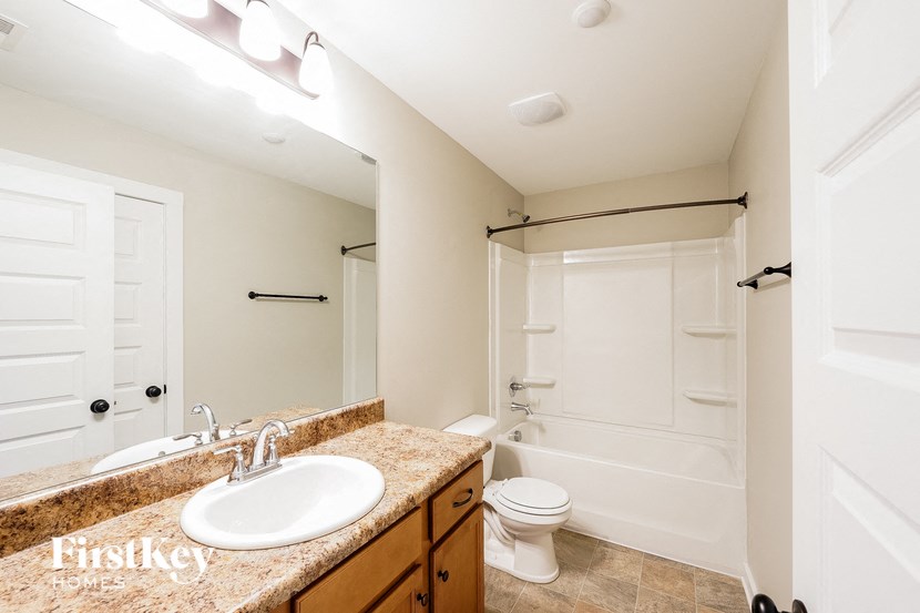 A bathroom with a sink, toilet, and bathtub.
