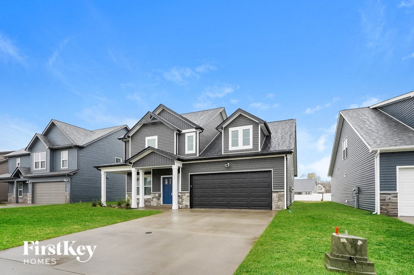 a large house with a driveway and a garage door