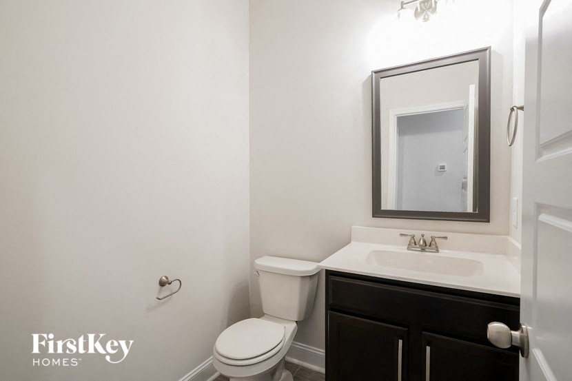 a bathroom with a toilet sink and a mirror