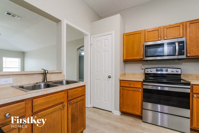 a kitchen with wooden cabinets and stainless steel appliances