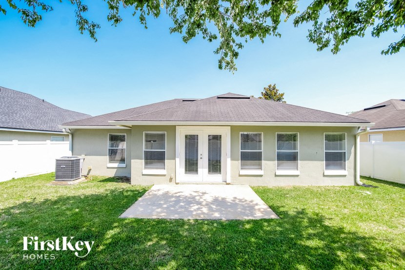 a white house with a yard and grass