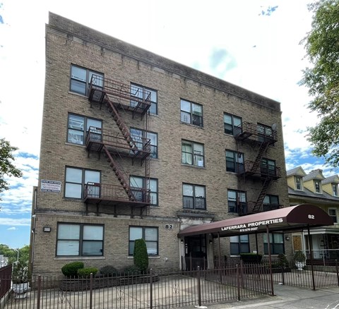 a brick apartment building with fire escapes