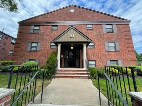 A red brick building with the number 81 on the front.