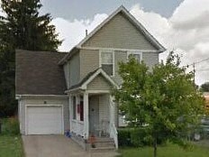 a gray house with a white garage door