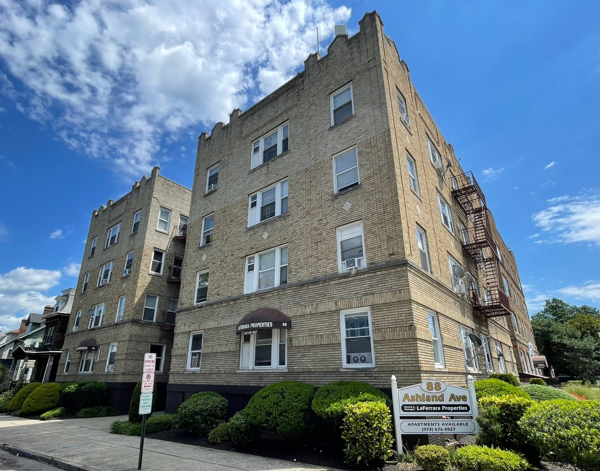 A tall apartment building with a sign in front that says "Ashland Ave.".