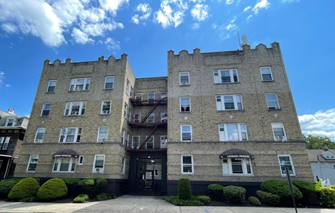 a large brick apartment building with turrets on top of it