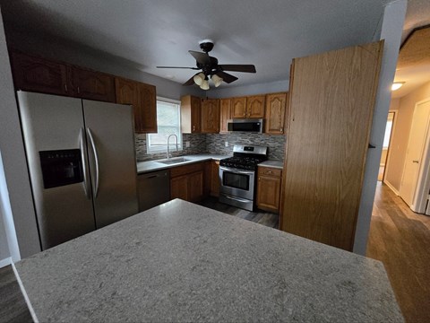 a kitchen with stainless steel appliances and wooden cabinets