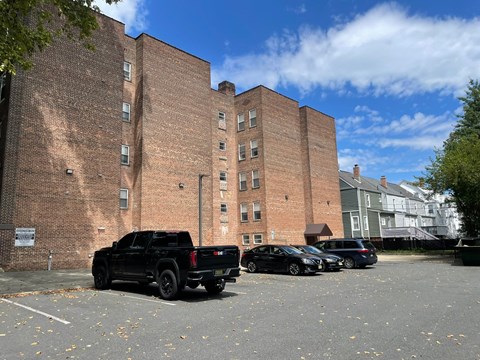 A black pickup truck is parked in a parking lot.