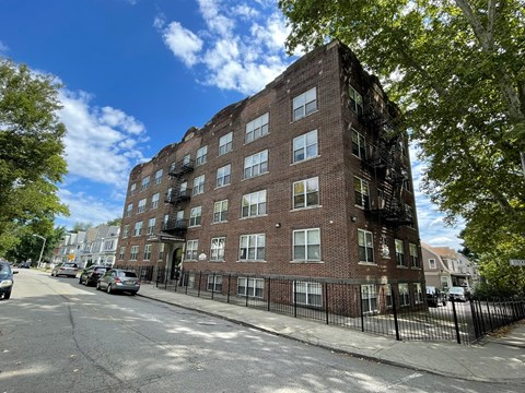 a red brick apartment building on a city street