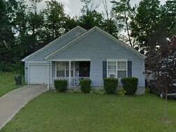 A small house with a white door and a porch.