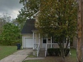 A house with a white door and a porch.
