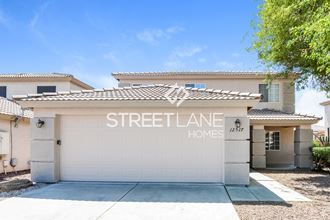 a home with a white garage door and a streetlance homes sign on it