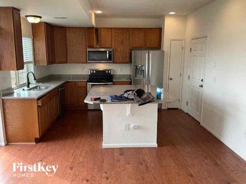 A kitchen with wooden cabinets and a white fridge.