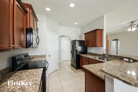 a kitchen with black appliances and granite counter tops
