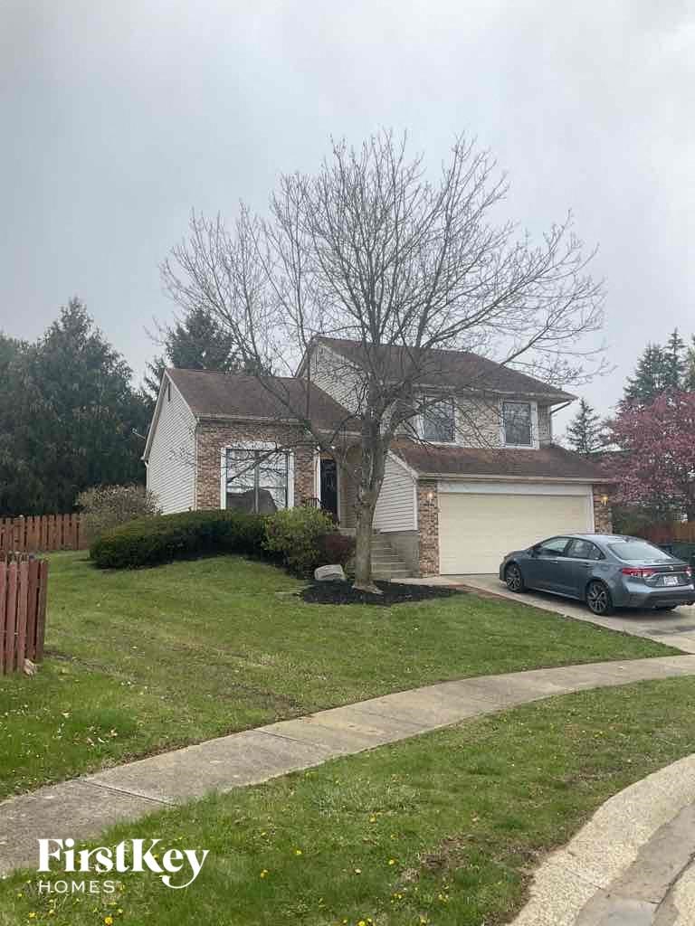 A house with a car parked in front of it.