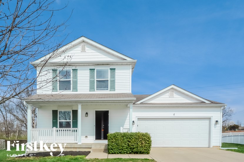 A two-story house with a white garage door.