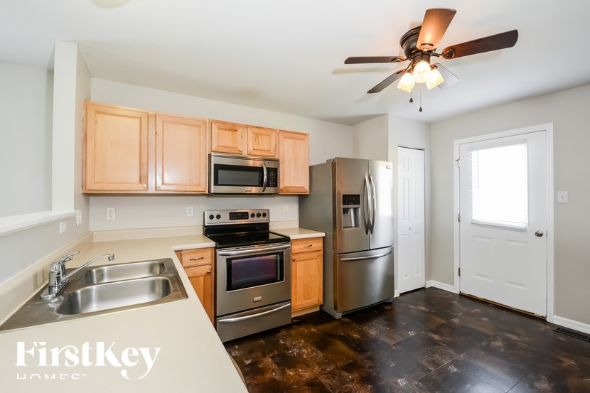 A kitchen with wooden cabinets and stainless steel appliances.