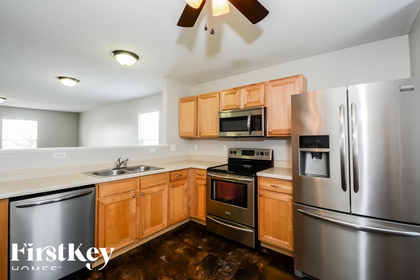 A kitchen with wooden cabinets and stainless steel appliances.