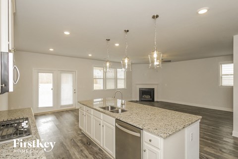 the kitchen of a new home with white cabinets and granite counter tops