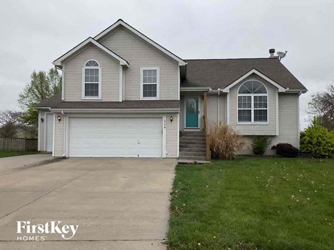 A two-story house with a garage is for sale.