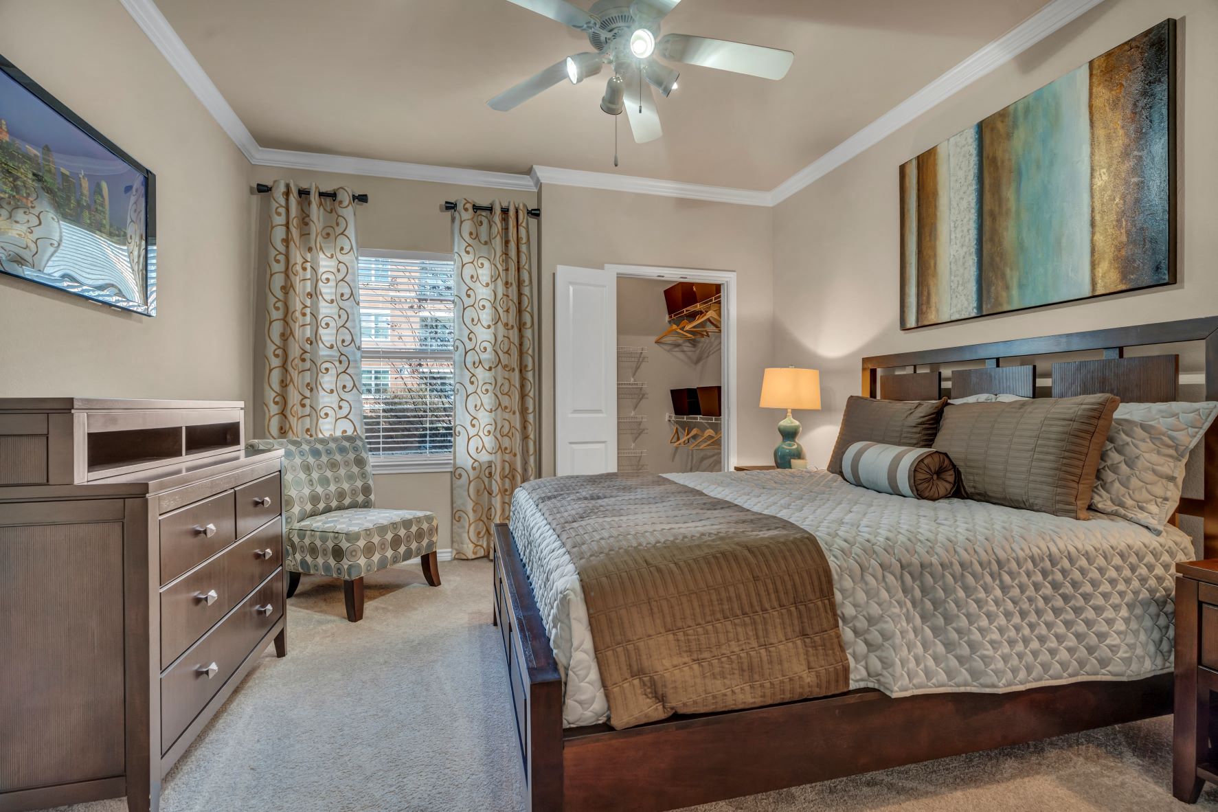 a bedroom with a bed and a ceiling fan
