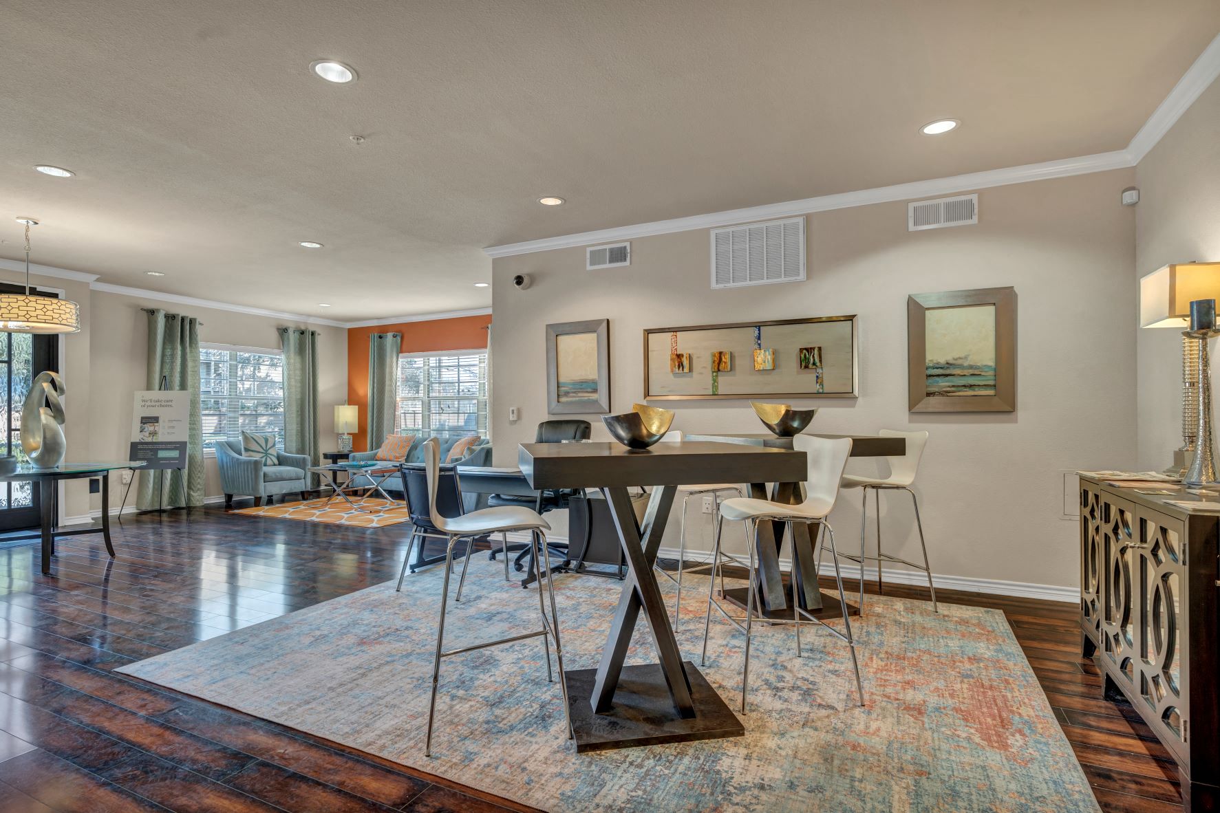 a living room with a dining room table and chairs