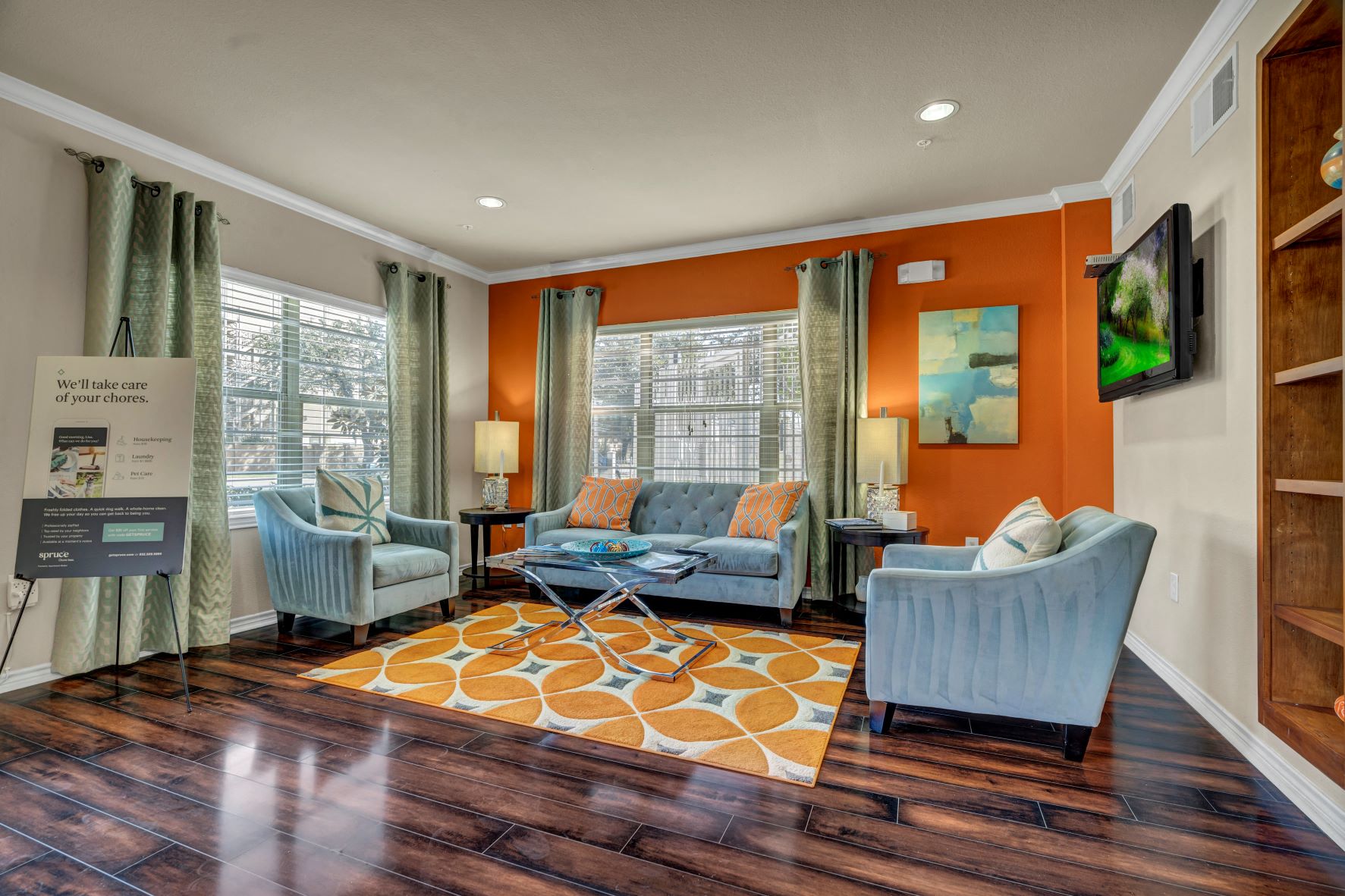 a living room with couches and chairs and a rug