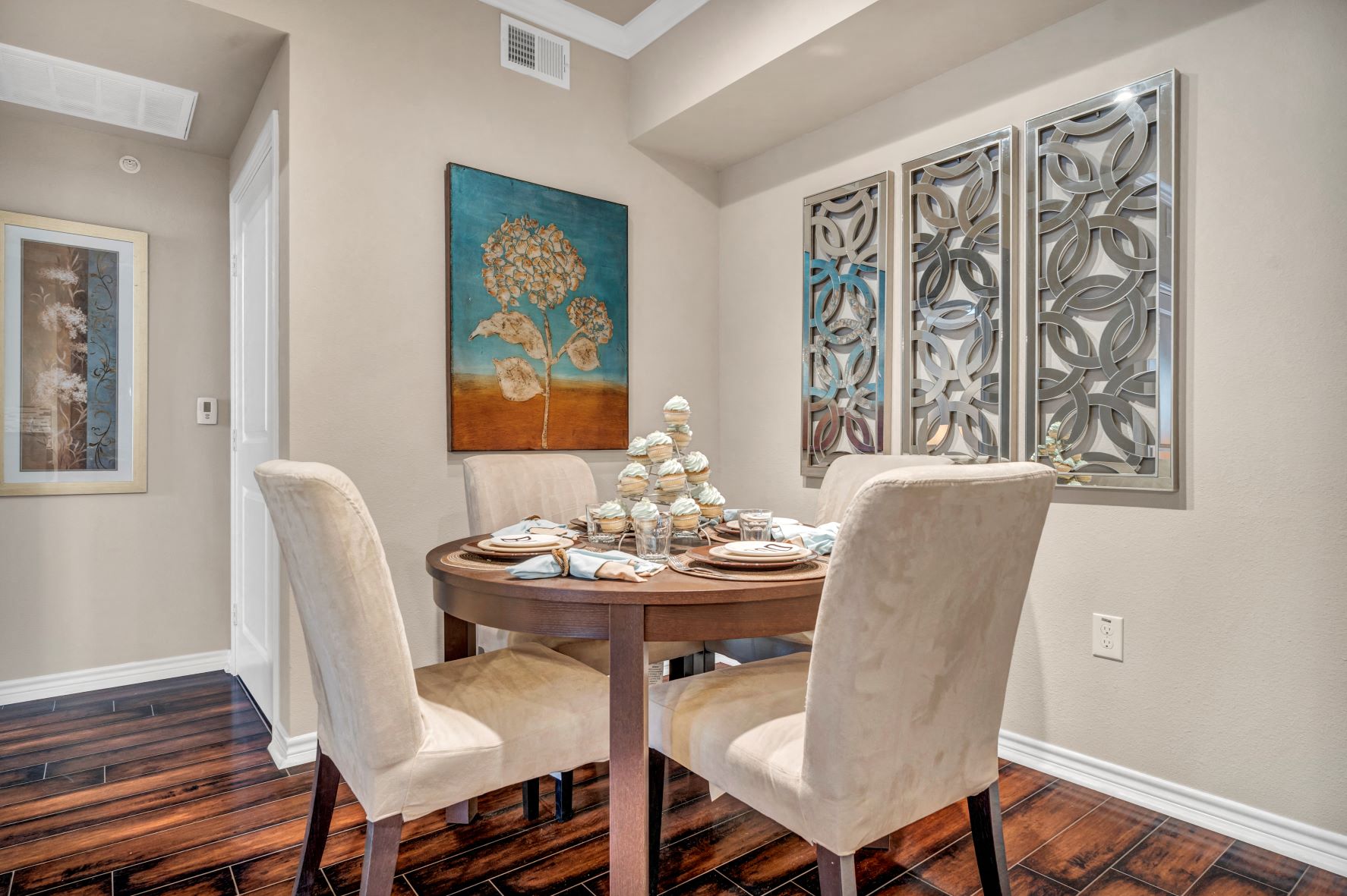 a dining room with a table and chairs