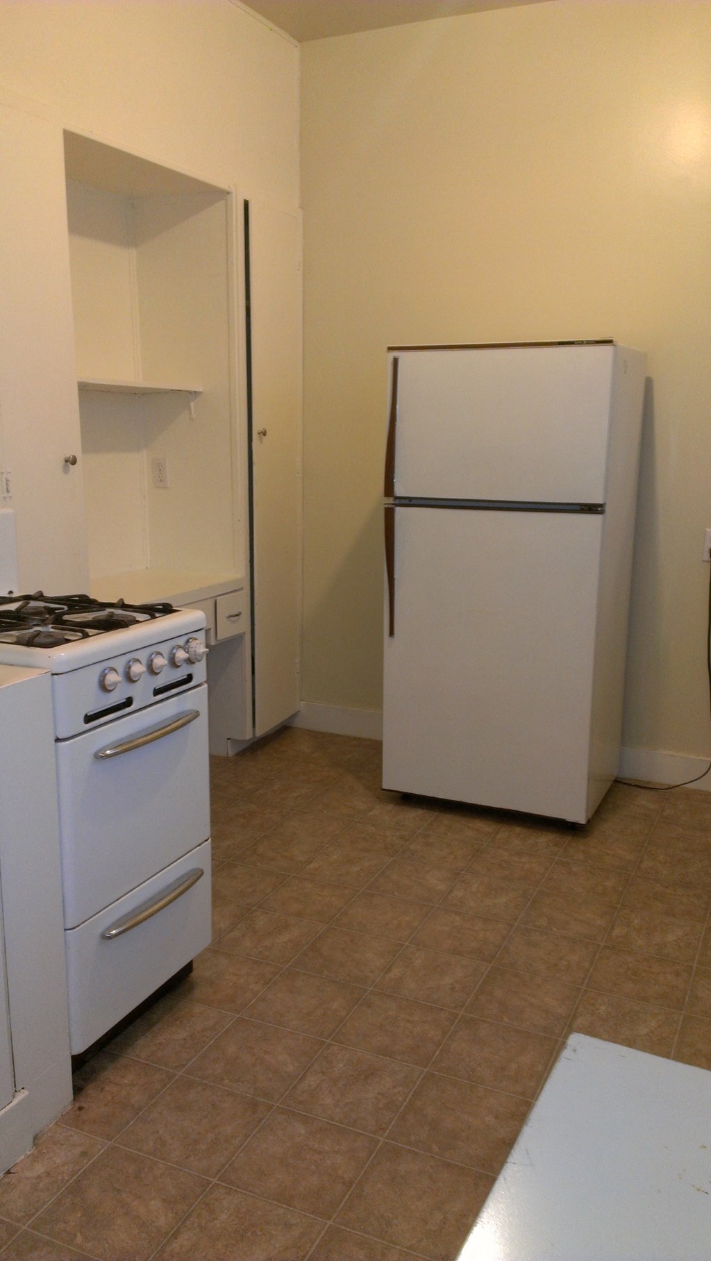 a kitchen with a stove and a refrigerator