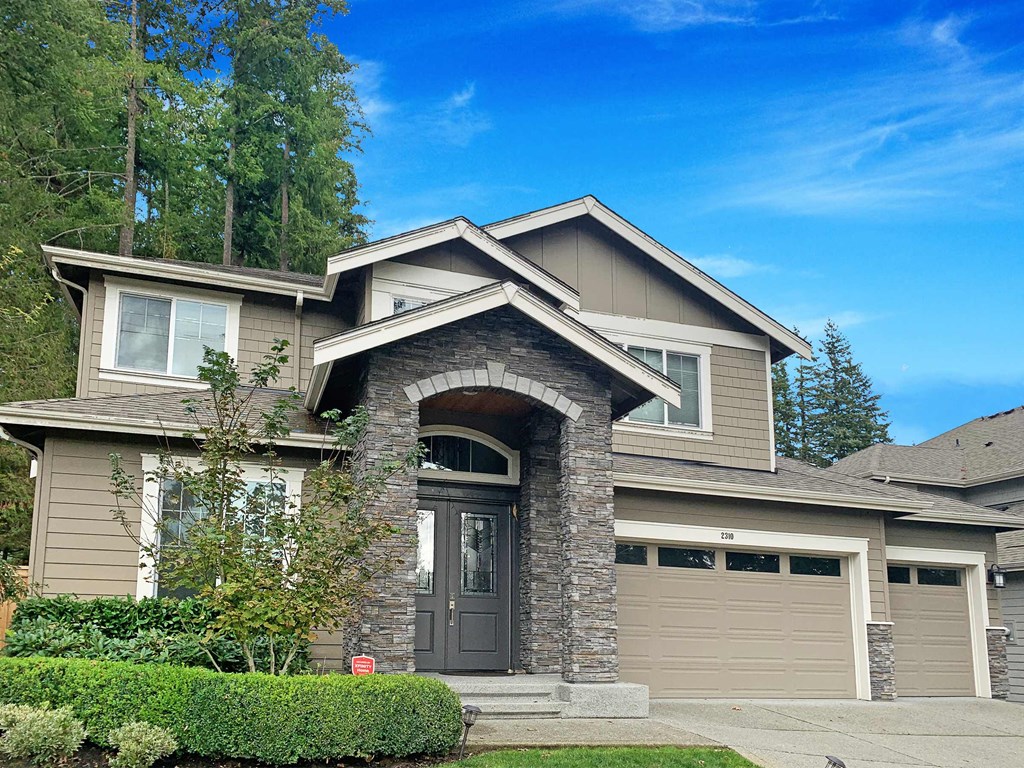 the front of a house with a garage door