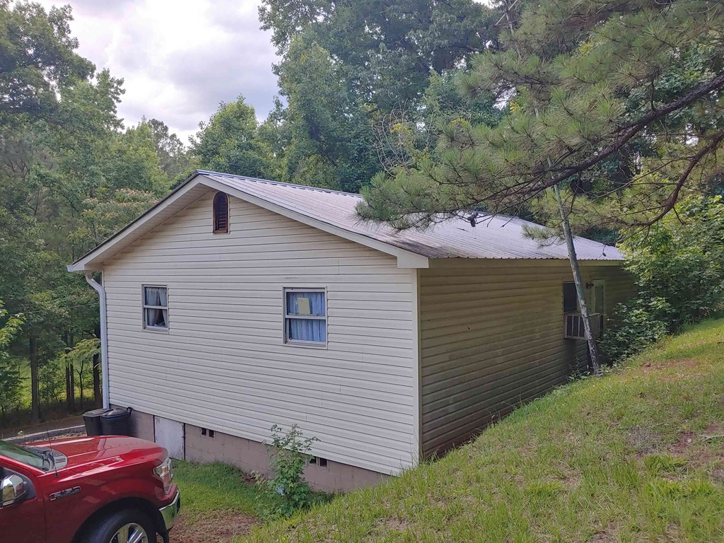 a house on a hill with a car parked next to it