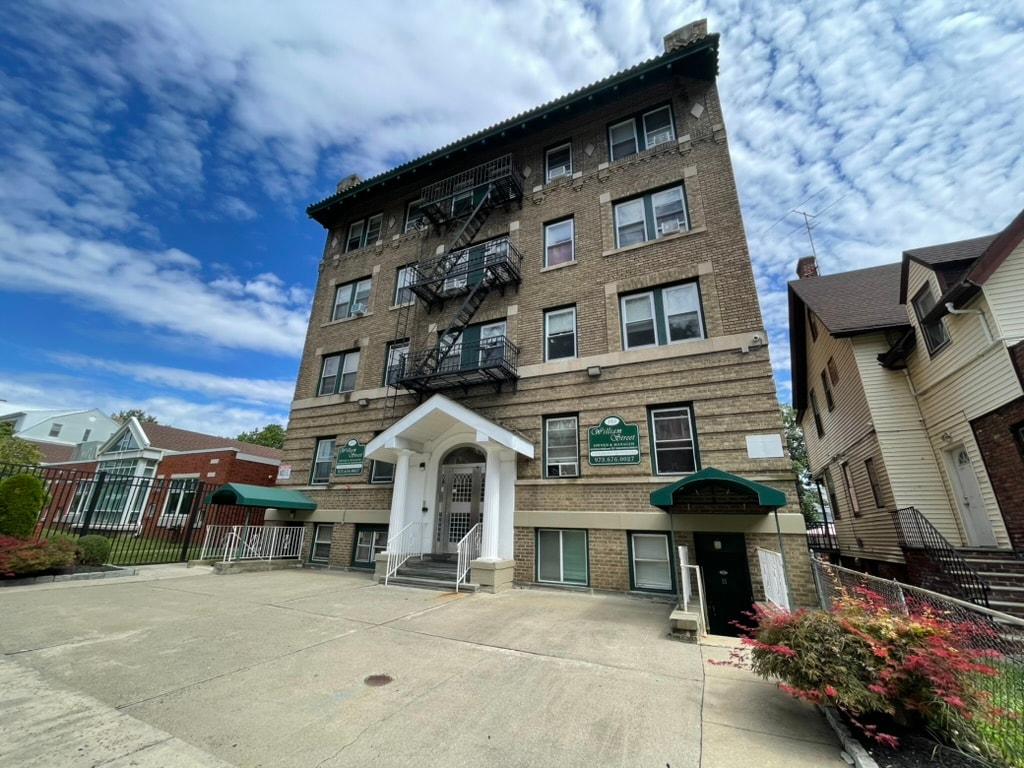 A large building with a green awning and a sign on the front.