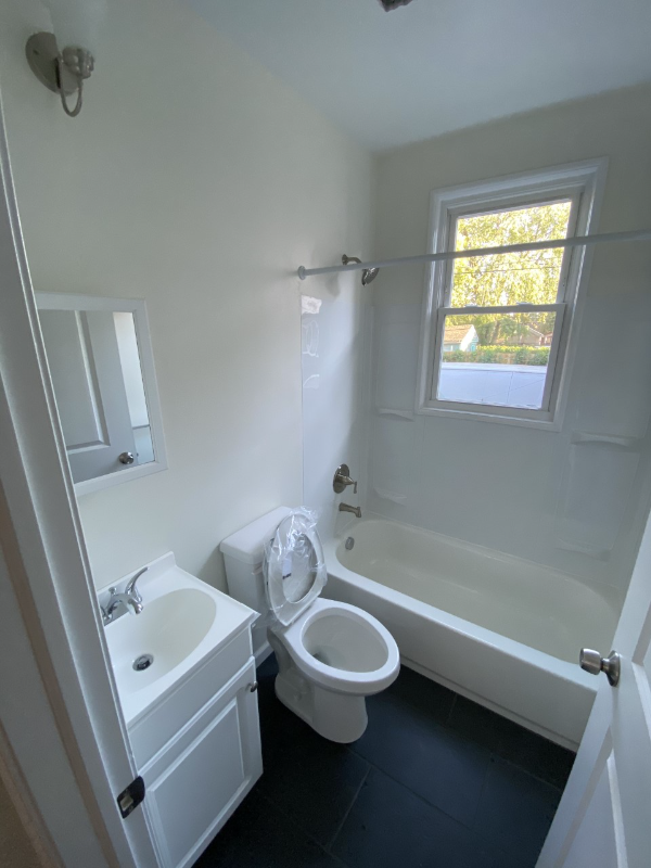 a small bathroom with a toilet sink and tub