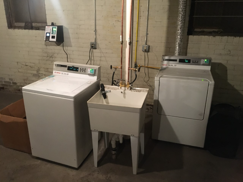two washing machines in a room next to each other