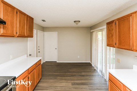 A kitchen with wooden cabinets and a white countertop.