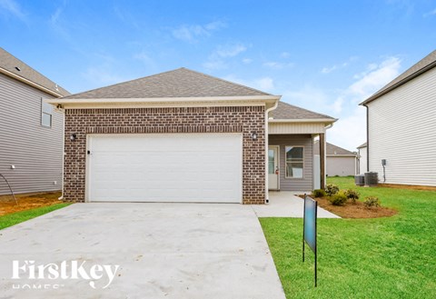 A house with a garage door and a sign that says FirstKey.