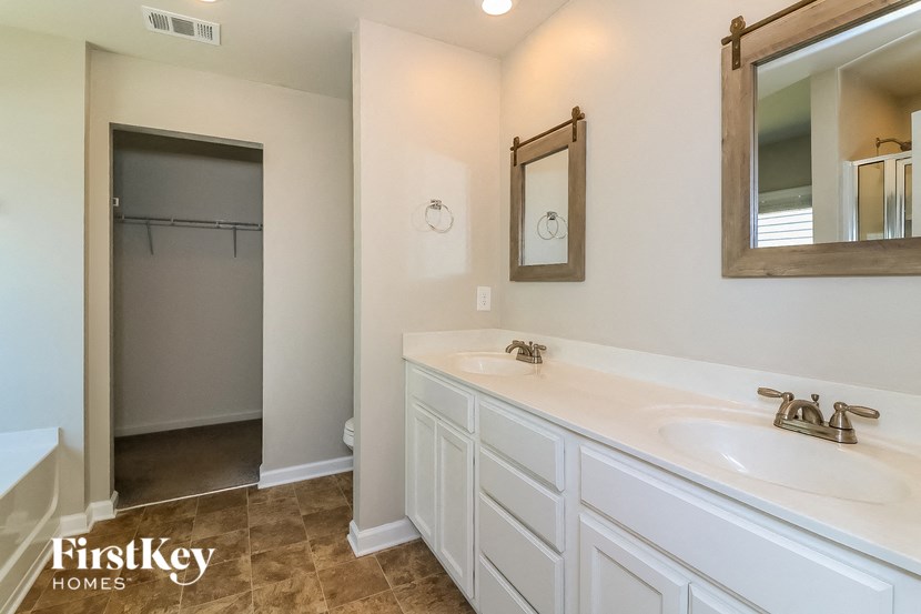 a bathroom with a sink and a mirror and a shower