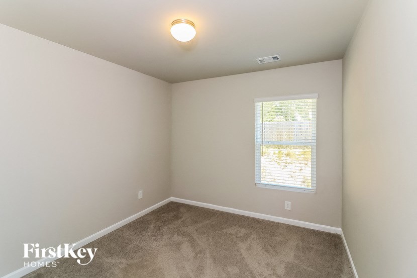 a room with a carpeted floor and a window