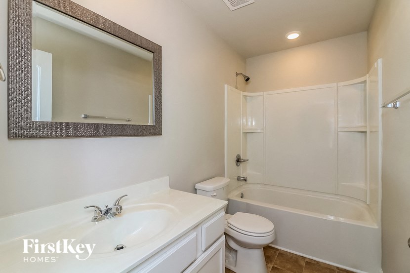 a bathroom with a sink toilet and a bath tub