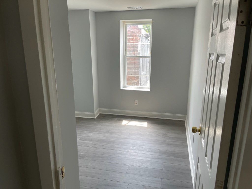 A room with a window and a door.