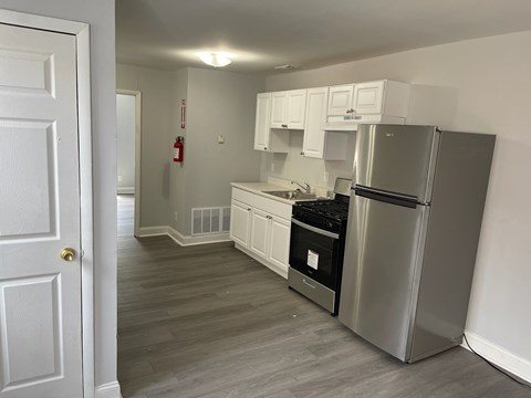 A kitchen with a stainless steel refrigerator and oven.