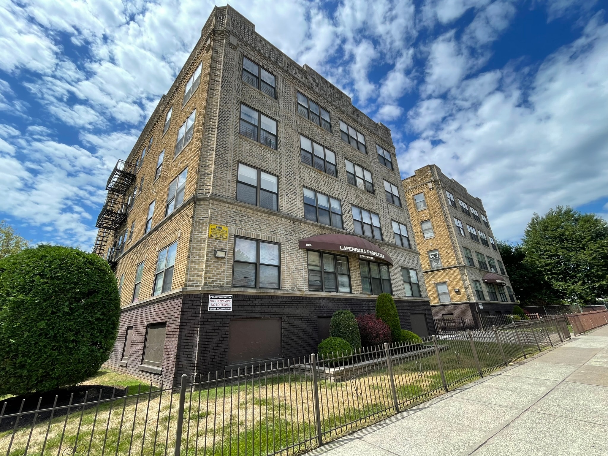 A large brick building with a sign that says "Lemon Grove Apartments".
