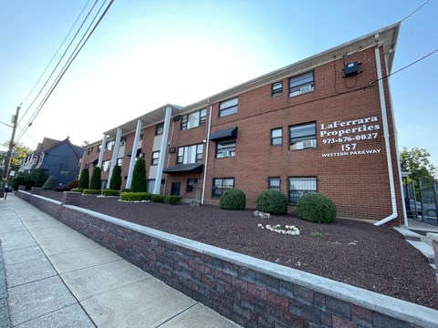 a brick building with a sidewalk in front of it