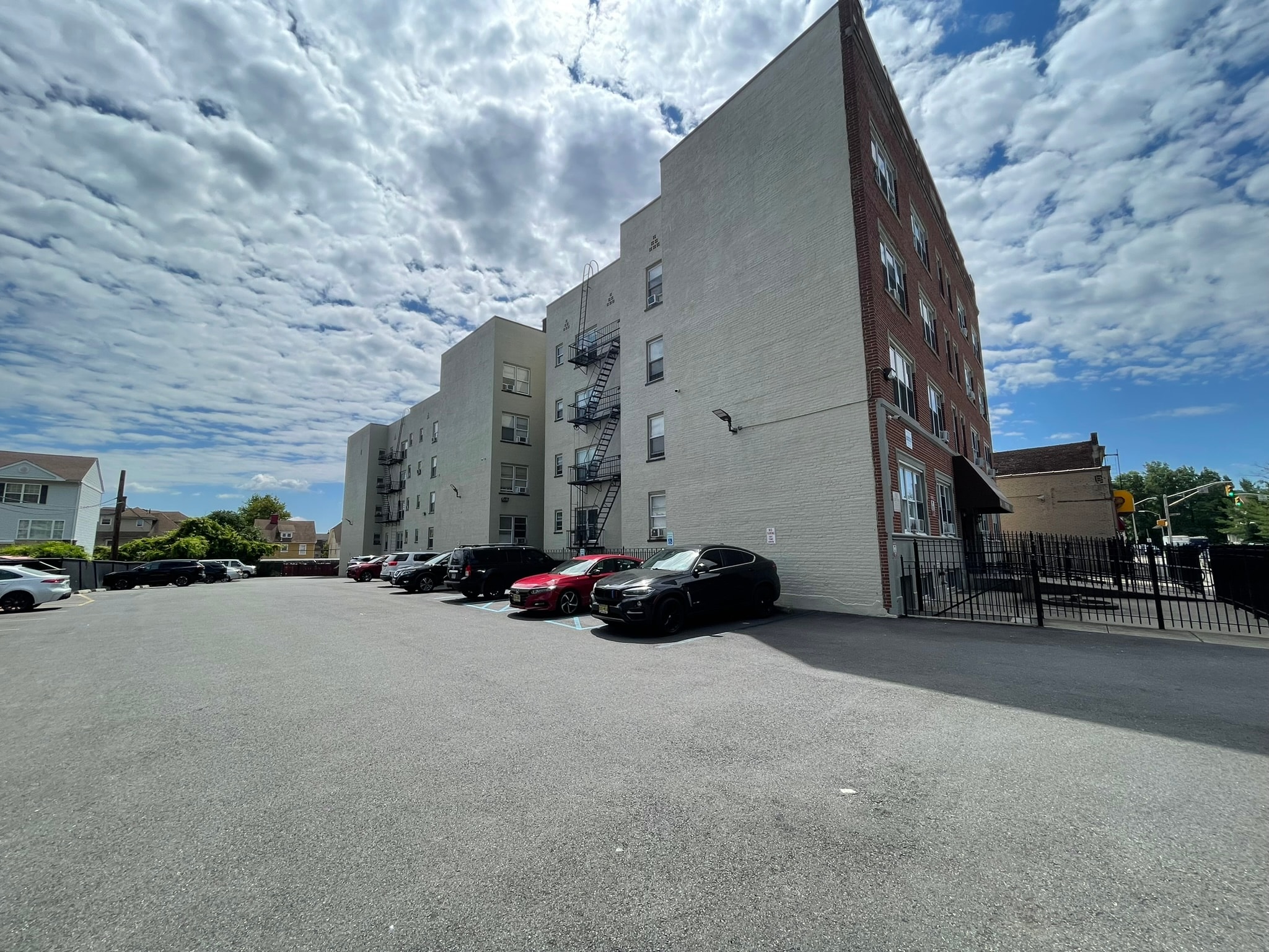 A parking lot with cars and a building in the background.